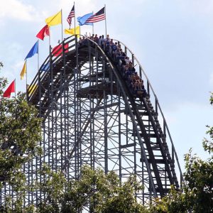 A train crests the first hill of The Voyage at Holiday World.