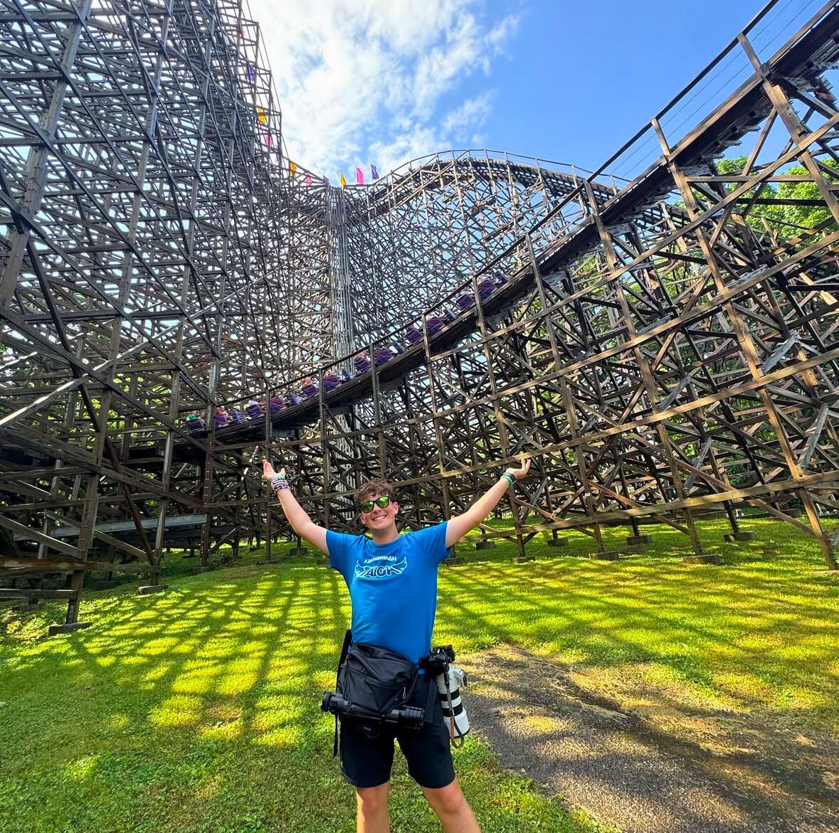 An enthusiast stands near The Legend lift hill