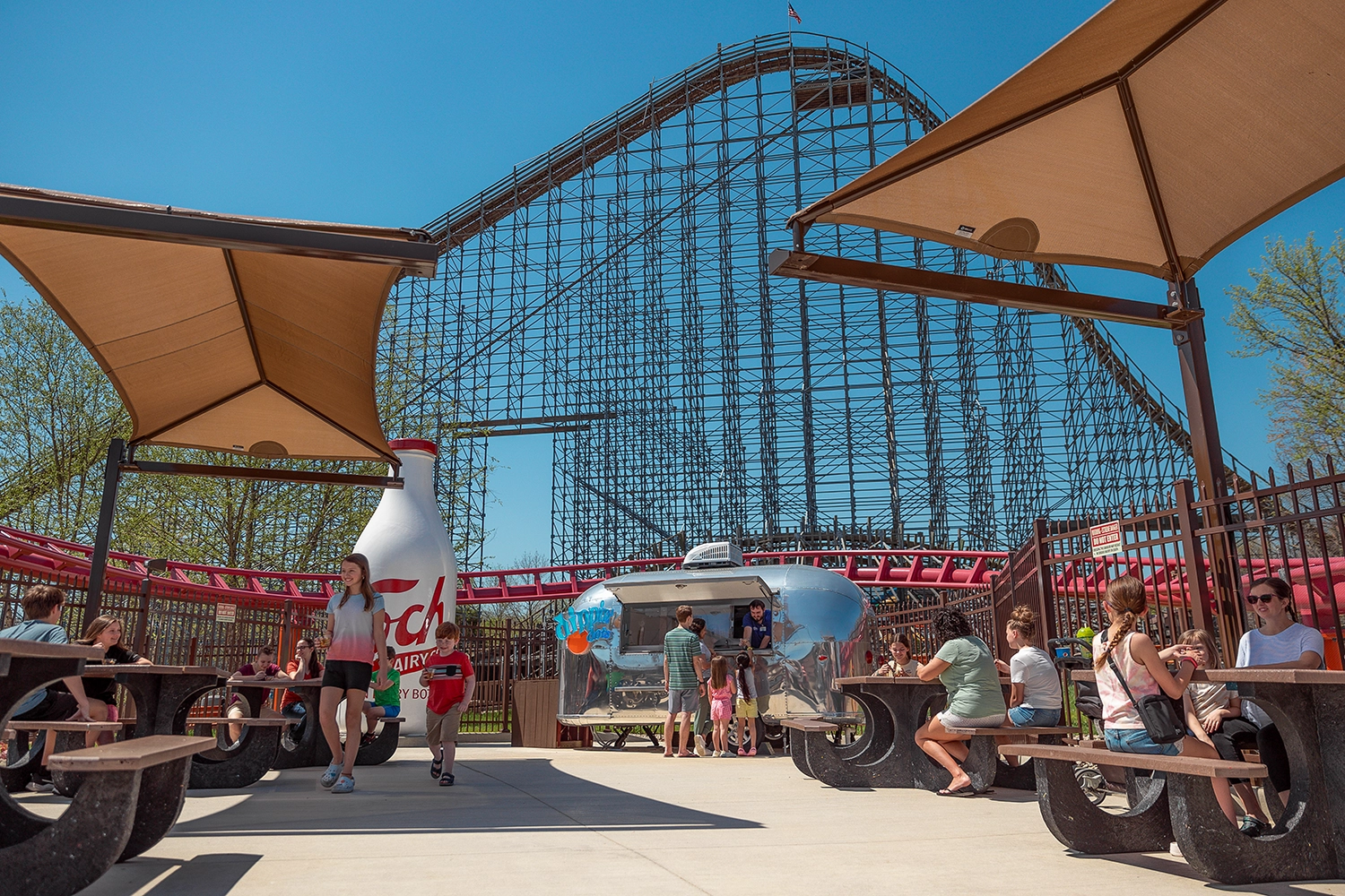 The Dippin' Dots Airstream located in Stuffing Springs with The Voyage's lift hill towering behind.