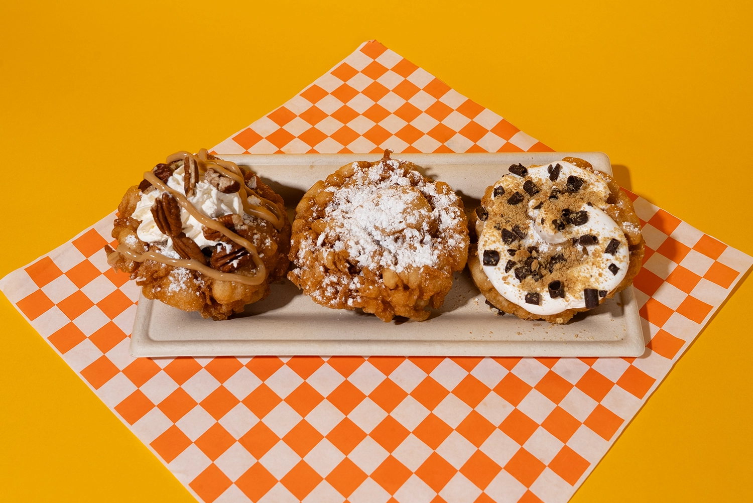 Funnel Cake Flight with 3 Mini Funnel Cakes - Maple Pecan, S'mores, and Classic - available during Happy Halloween Weekends at Holiday World.