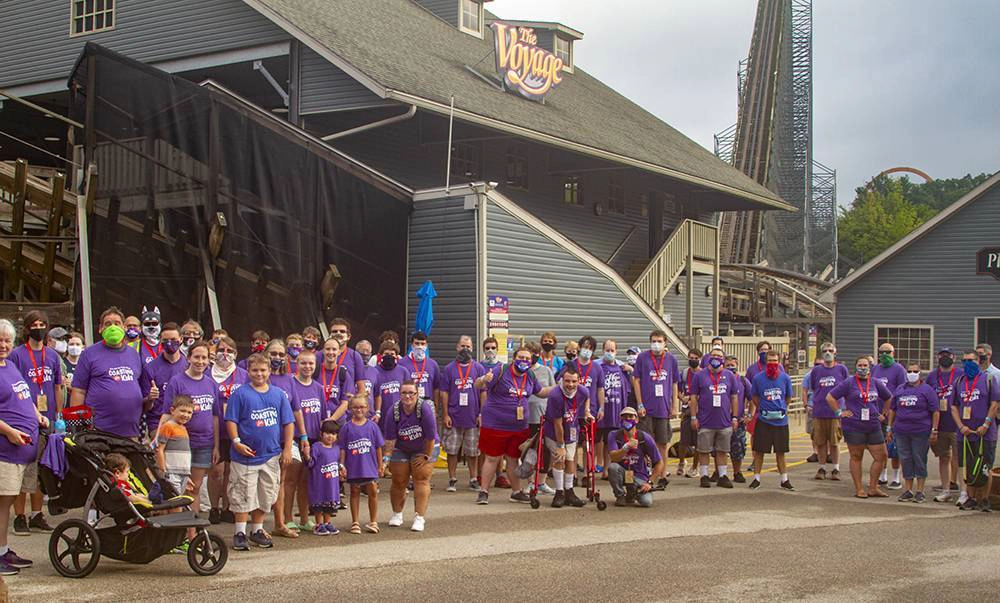 The 2020 "Coasting for Kids" participants benefiting Give Kids the World posed in front of The Voyage at Holiday World.