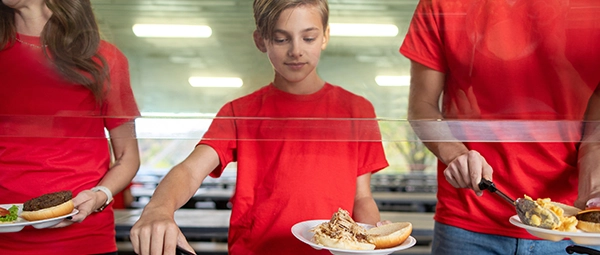 A boy fills his plate in the Good Old Days Picnic Grove.