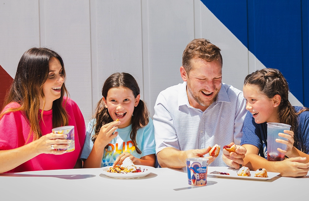 A family enjoys exclusive food items during Summer Wine'd Down at Holiday World.