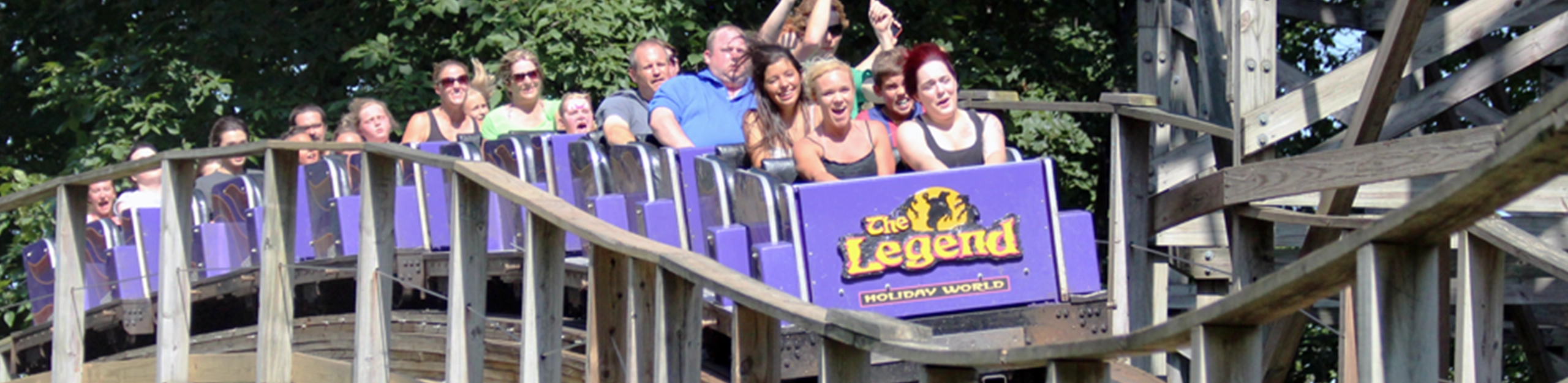 A train snaking through the track of The Legend Wooden Roller Coaster at Holiday World & Splashin' Safari in Santa Claus, Indiana.