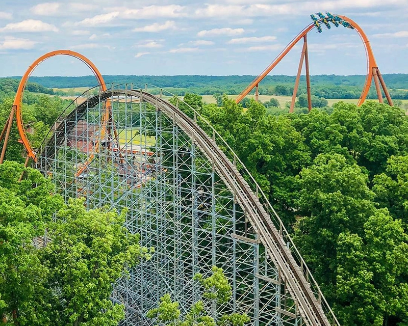 Aerial view of Thunderbird looping through the Immelmann with Voyage's second hill in the foreground.